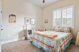 Bedroom featuring carpet and ceiling fan