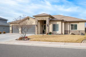 View of front of property with a front lawn and a garage