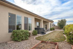 Exterior space with a hot tub and a patio