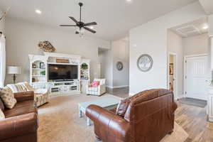 Living room with ceiling fan and wood-type flooring