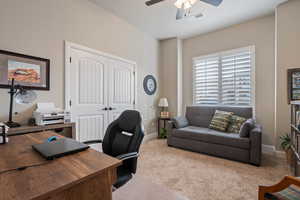 Carpeted home office with ceiling fan