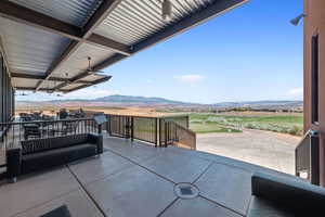 View of patio with an outdoor living space, ceiling fan, and a mountain view