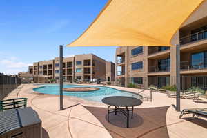 View of pool featuring a jacuzzi and a patio area