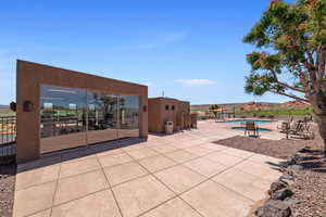 View of patio with a mountain view and a community pool