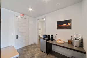 Hall with dark hardwood / wood-style floors