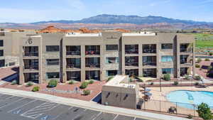 View of building exterior with a mountain view and a community pool