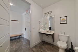 Bathroom with hardwood / wood-style flooring and toilet