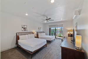 Bedroom featuring carpet flooring, a textured ceiling, ceiling fan, a wall mounted AC, and access to exterior