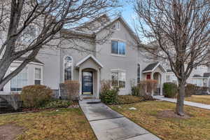 View of property with a front lawn