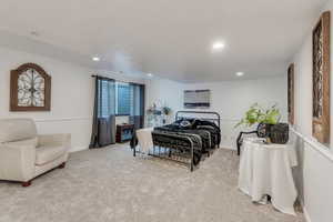 Bedroom featuring light colored carpet