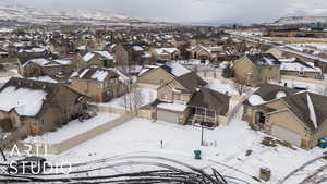 Snowy aerial view featuring a mountain view