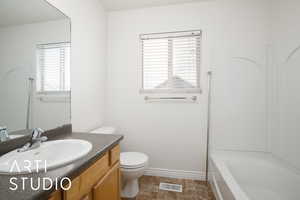 Full bathroom featuring vanity,  shower combination, and toilet