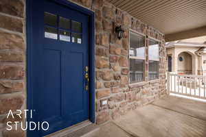 Doorway to property with covered porch