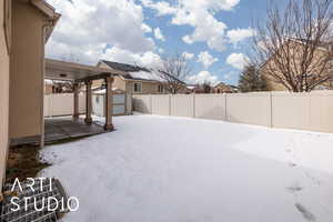 Snowy yard featuring a storage shed