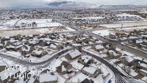 Snowy aerial view featuring a mountain view