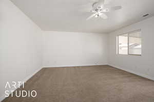 Carpeted empty room with ceiling fan