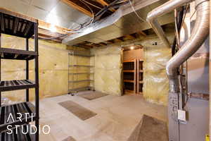 Basement featuring heating unit