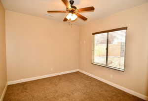 Empty room with carpet flooring and ceiling fan