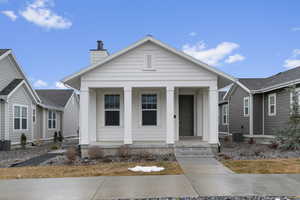 Bungalow-style house with central air condition unit and a porch