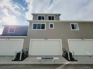 Back of house featuring central AC (2 units) and a garage. There is no parking on this shared access road