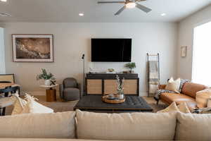 Living room with ceiling fan, a healthy amount of sunlight, and light hardwood / wood-style floors