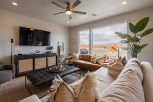 Living room featuring hardwood / wood-style flooring and ceiling fan