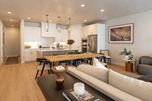 Living room with sink and light hardwood / wood-style flooring