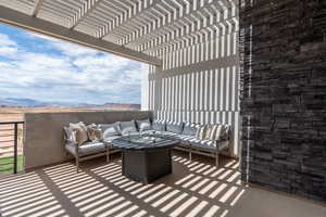 Balcony with a pergola, an outdoor living space with a fire pit, and a mountain view