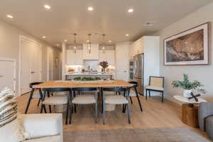 Dining area featuring sink and light hardwood / wood-style floors