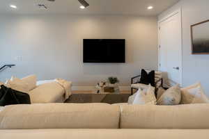 Living room with hardwood / wood-style floors and ceiling fan