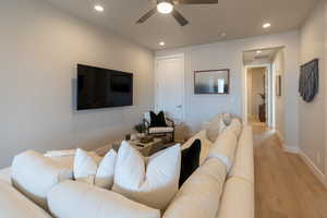 Living room featuring light hardwood / wood-style flooring and ceiling fan