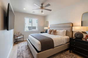 Bedroom with light hardwood / wood-style floors and ceiling fan