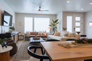 Living room featuring a textured ceiling, hardwood / wood-style floors, and ceiling fan