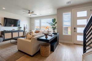 Living room featuring light hardwood / wood-style floors and ceiling fan