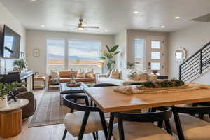 Living room featuring hardwood / wood-style flooring, a mountain view, a textured ceiling, and ceiling fan