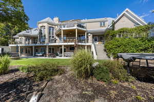 Rear view of house with a patio and a balcony