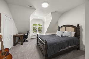 Bedroom featuring light carpet, a textured ceiling, and lofted ceiling