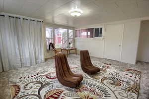 Sitting room featuring light carpet