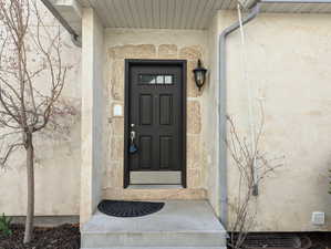 Entrance to property featuring stucco siding