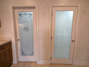 Entryway featuring baseboards and light tile patterned flooring