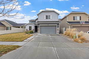 View of front facade featuring a front lawn and a garage