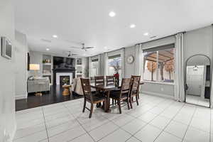 Dining space featuring light tile patterned floors, ceiling fan, and built in features