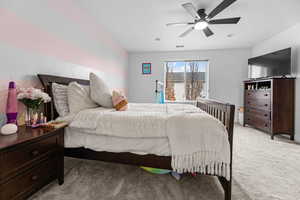 Carpeted bedroom with ceiling fan