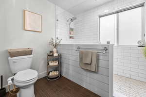 Bathroom with toilet and tiled shower