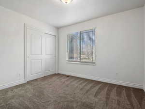 Unfurnished room with carpet