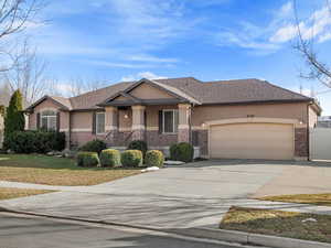 View of front of house featuring a garage and a front yard