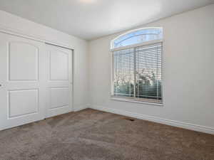 Unfurnished bedroom with a closet and carpet flooring