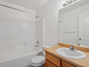 Full bathroom with bathing tub / shower combination, vanity, and toilet