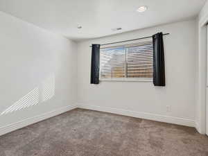 Unfurnished room with carpet