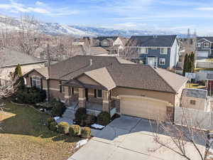 View of front of home featuring a mountain view, a garage, and covered porch